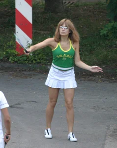 Pretty girl playing tennis in a skirt and walking in jeans