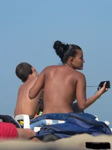 Hot ass topless beach girl with great tits lets her little brother oil up her ass in thong bikini