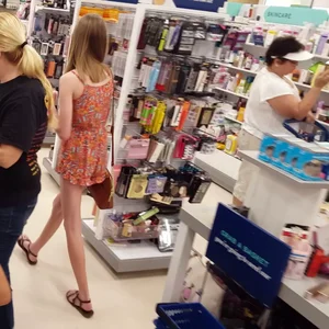 Tall skinny girl wearing sandals and a short dress a tthe store