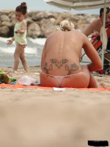 Tattooed blonde with big tits topless and in thong