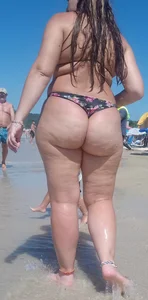 Fat ass milf at the beach in a thong bikini