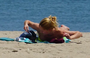 Sexy ass blonde milf on the beach in a thong with cameltoe and bending over