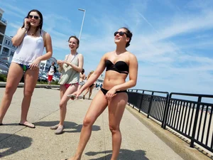 Cute brunette looking sexy in black bikini with friends