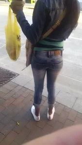 Skinny booty and legs in tight blue jeans on the street creepshot
