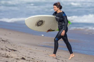 Candid girls surfing on the beach