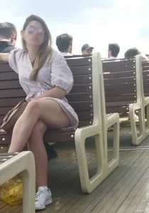 An Amazingly Hot Candid Girl in a Short Dress Sitting on a Bench on a Boat With Crossed Legs Creepshots Series