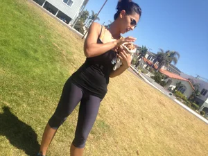 Hot brunette babe in leggings walking her dog with a nice ass and some cleavage