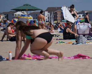 Sexy beach brunette in teal top and black bottom bikini