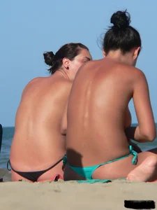 Bunch of sexy babes on the beach topless and in thong bikinis