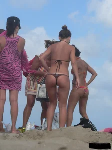 Sexy beach lady in tiny brown thong bikini with a nice ass