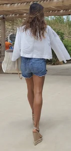 Flat ass leggy girl in denim shorts