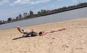 Girl laying out getting sun in a white thong bikini