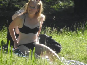 Two sexy friends in black bikinis laying out