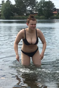 Big boobed babe at the lake in a black thong with blonde friend