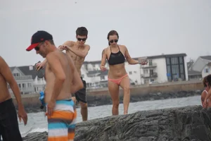 Peach bikini tattood babe on the beach with a nice ass and some camel toe