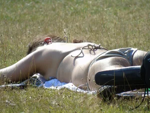 Bikini girl laying out in the park