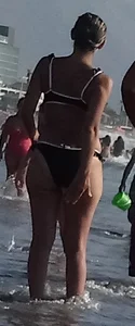 Milf with a big booty in a bikini at the beach
