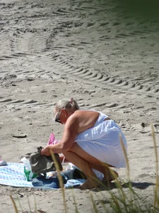 Mature blonde lady on a nude beach with big boobs