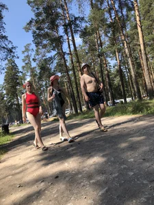 Candid Teen in a Body Swimsuit Walking on a Forest Road