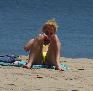 Sexy ass blonde milf on the beach in a thong with cameltoe and bending over