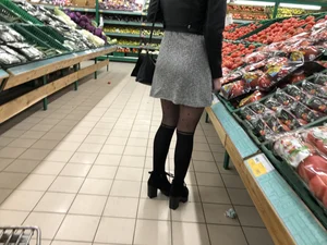 Hot milf wearing a skirt and black pantyhose with dots at the grocery store creepshot