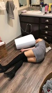 Girl in Over the Knee Boots and a Dress Asleep on the Bathroom Floor