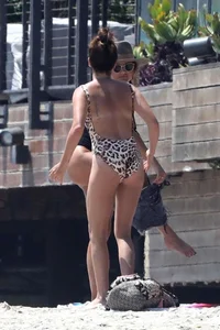 Ashley Tisdale in cheetah print swimsuit on the beach in Malibu