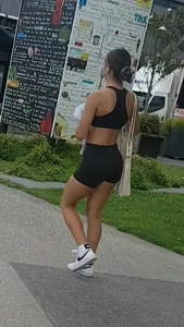 Fit girl in a sport top and spandex shorts street creepshot
