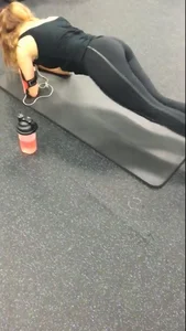 Sexy gym girl with a nice body in leggings as she works out