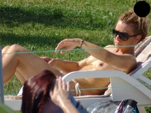 Topless lady at the pool with nice tits