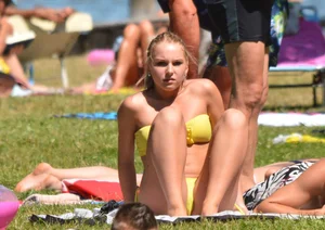 Blonde looking sexy in a yellow bikin