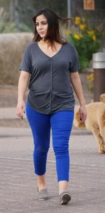 Sexy dog walker in shorts and tank top with friend in blue jeans