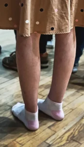Skinny Legs And Feet in White Socks of a Teen Candid Girl in a Dress