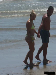 Sexy blonde on the beach in a yellow thong bikini