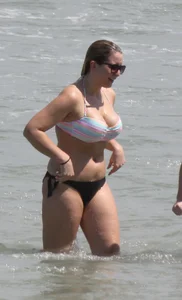 Big boobed thick blonde on the beach in a bikini