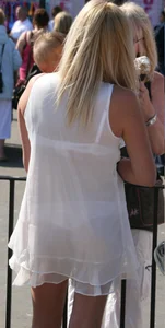 Blonde girl in a semi-transparent dress with contours of her underwear visible