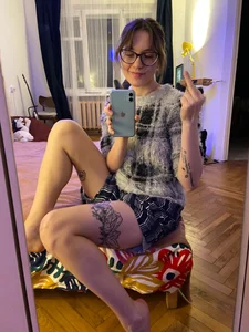 Girl in Glasses With Sexy Legs in Shorts Showing Middle Finger Mirror Selfie