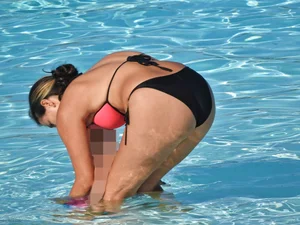 Sexy milf with a nice mom bod in a bikini in the pool