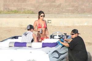 Brunette on a boat in red thong bikini with a tight little ass