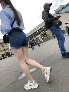 Candid Girl in Blue Denim Shorts and Sneakers Walking Down the Street - Hot Legs Crepshots Collection