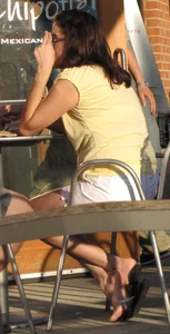 Lady in flop flops while eating showing her feet
