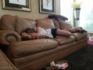 Skinny Girl in Shorts Asleep on the Couch Candid Photo
