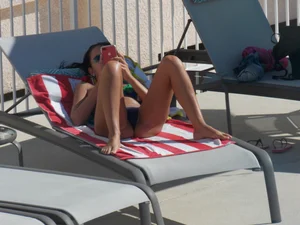 Hot milf sunbathing in a thong by pool and swimming