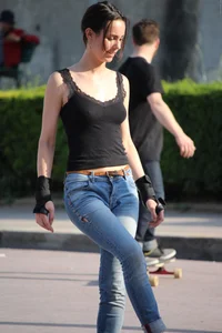 Hot brunette skateboarder in tight jeans and with hard nipples