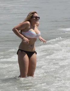 Big boobed thick blonde on the beach in a bikini