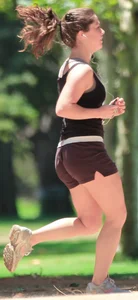 Cute girl running in short shorts