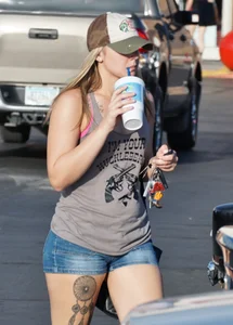 Hot blonde after shopping in short jean shorts and tank top