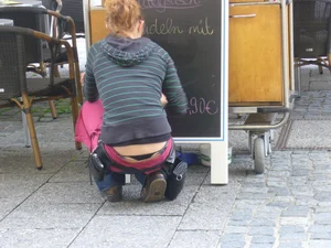 Girl With Little Ass Squatting in front on the Blackboard at the Street Restaurant Whaletail Creepshot