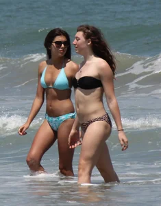 Brunette and redhead on the beach in bikinis looking sexy