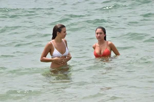 Two sexy ass girls on the beach in bikinis